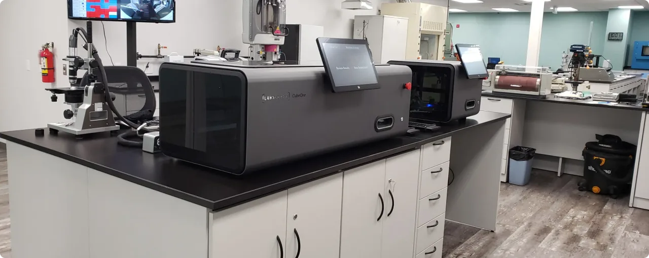 LabsCubed CubeOne and CubeTen automated tensile testing machines in a modern material testing laboratory.
