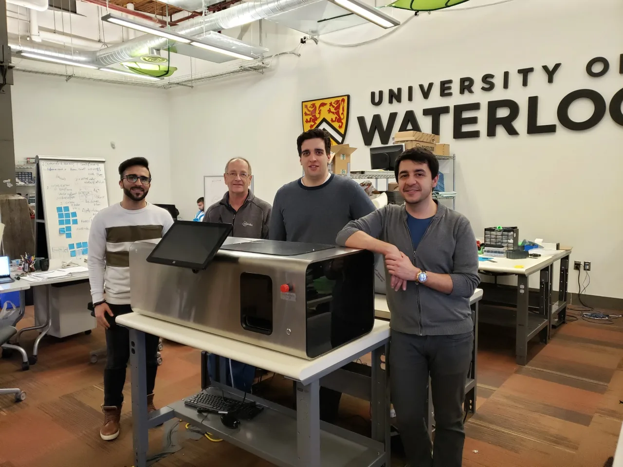 The LabsCubed founding team with an early automated tensile testing prototype at the University of Waterloo.