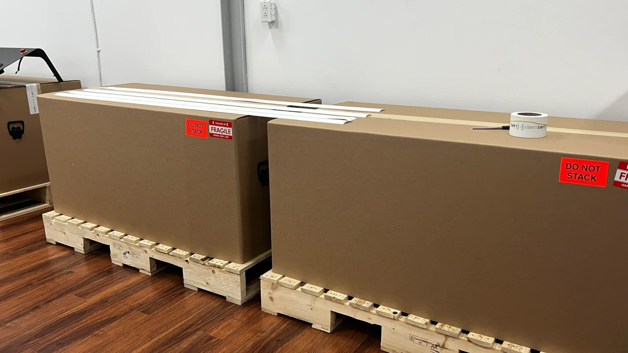Crated full-production CubeOne machines on pallets, ready to ship to customers.