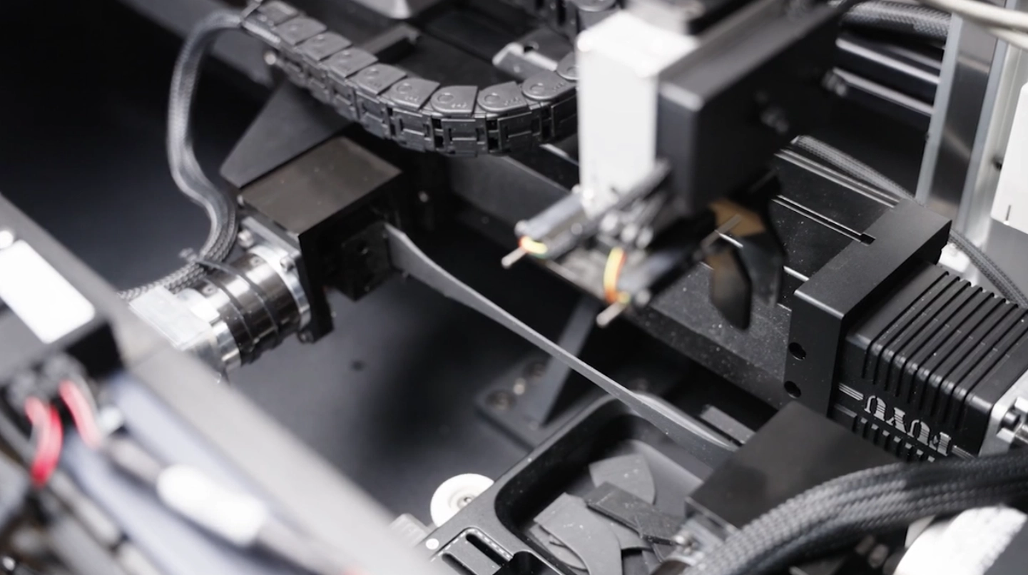 CubeOne running tensile testing on rubber samples.